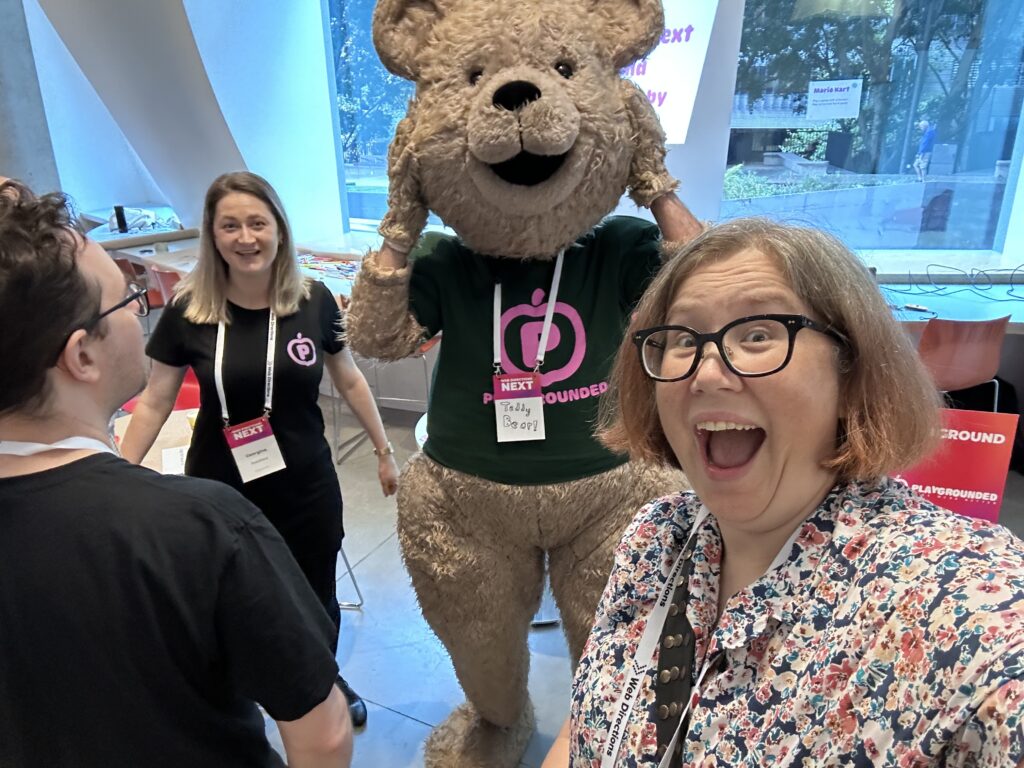 Me making an excited face next to a guy dressed as a giant teddy bear