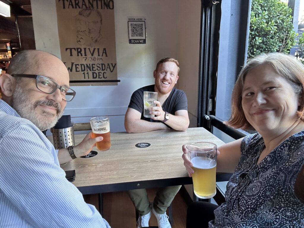 Three people smiling at a pub