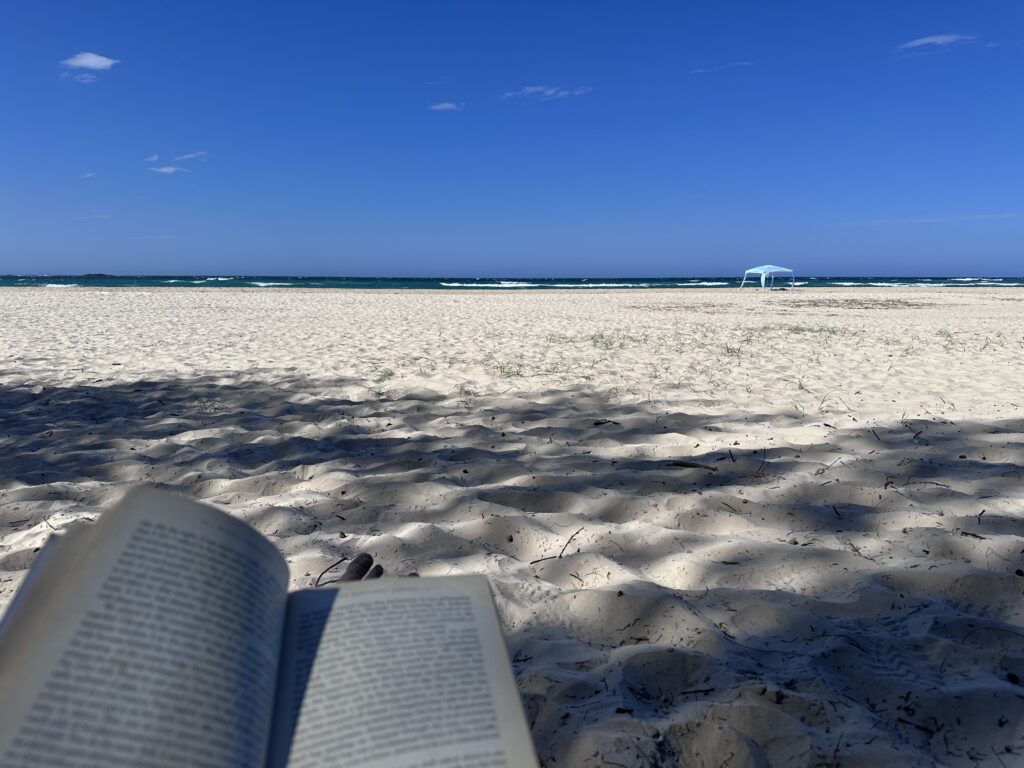 Reading on the beach at Straddie