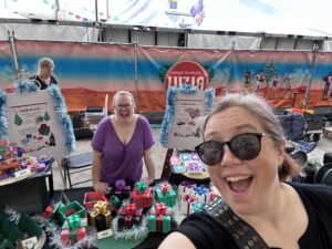 Two women at a craft stall at a market