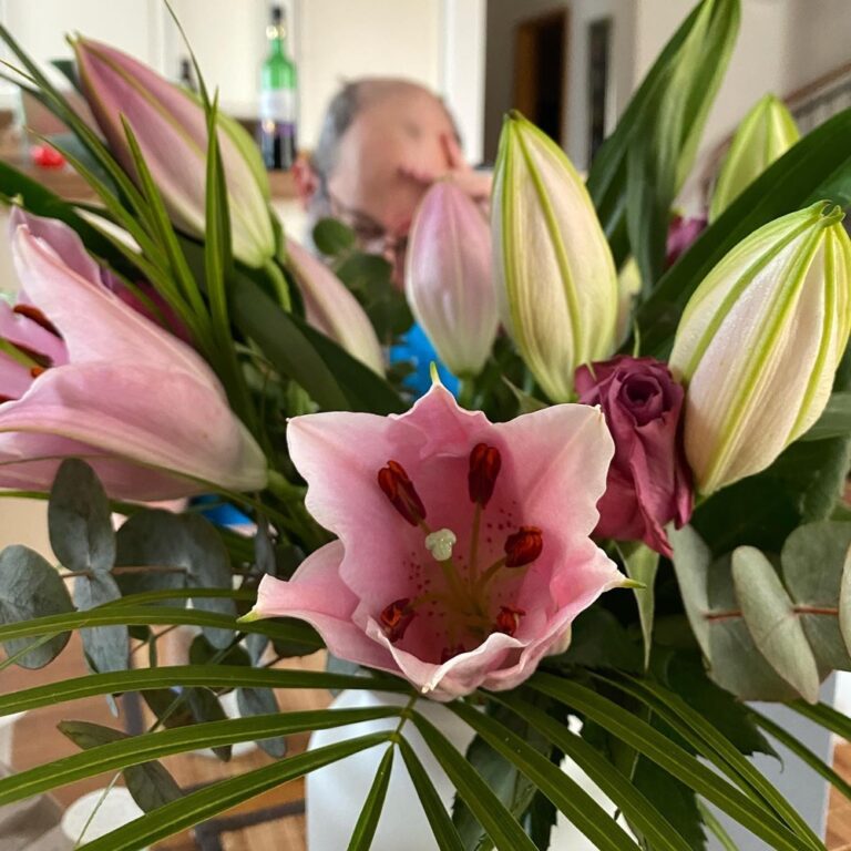 Mom sent me some lovely birthday flowers, but they do make it rather difficult to see my breakfast companion! 💐