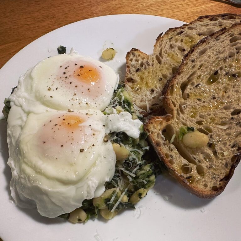 Garlicky white beans with spinach, poached eggs, and toast. #yummy 🍳