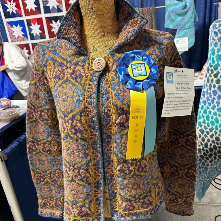 A fun outing to the Elkhart County Quilt & Fiber Expo! I did some knitting with Katy from @yarnadventuretruck for #wwkipday, and some of her lovely wool came home with me. Also checked out the exhibits and took some photos of my favorite quilts. There were only a few knitted pieces, but there was a lovely Starmore jacket! I also spent some time checking out a genuine 19th century woven corset and geeking out over historical undergarment manufacturing. 🧶🧵🪡 @wwkipday