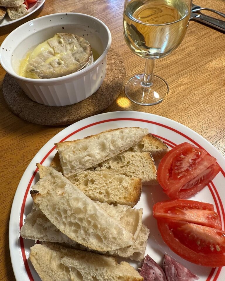 We poked holes in the top of the @longpaddockcheese Driftwood, splashed on some white wine, stuck in bits of slivered garlic, and baked until it was warm and gooey. Now dunking crusty bread and day-drinking like damn hell ass kings. 🧀 🥖 🍷