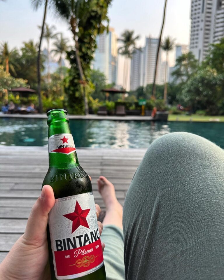 Enjoying a sunset Bintang by the pool in Jakarta. Travel does have its upsides… 🌴🌅🍺