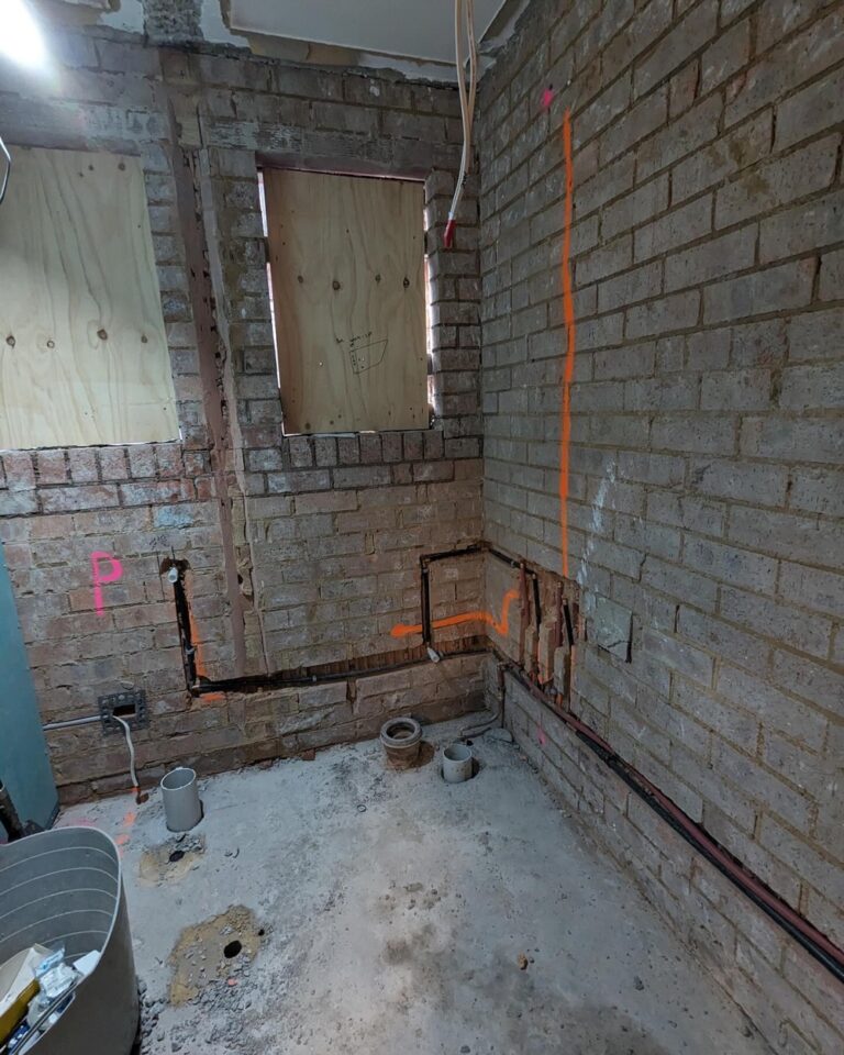 Week 3: Two of the new walls are built, and plumbing and electrical have been chased in. Our bathroom is finally a rectangle! The internet has been moved to a more practical location, and we can start to see what the back entrance hallway will look like. Next up is to fix the very uneven floor before plastering can begin… 🏠🚧