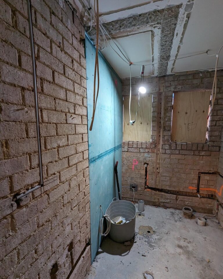 Week 3: Two of the new walls are built, and plumbing and electrical have been chased in. Our bathroom is finally a rectangle! The internet has been moved to a more practical location, and we can start to see what the back entrance hallway will look like. Next up is to fix the very uneven floor before plastering can begin… 🏠🚧