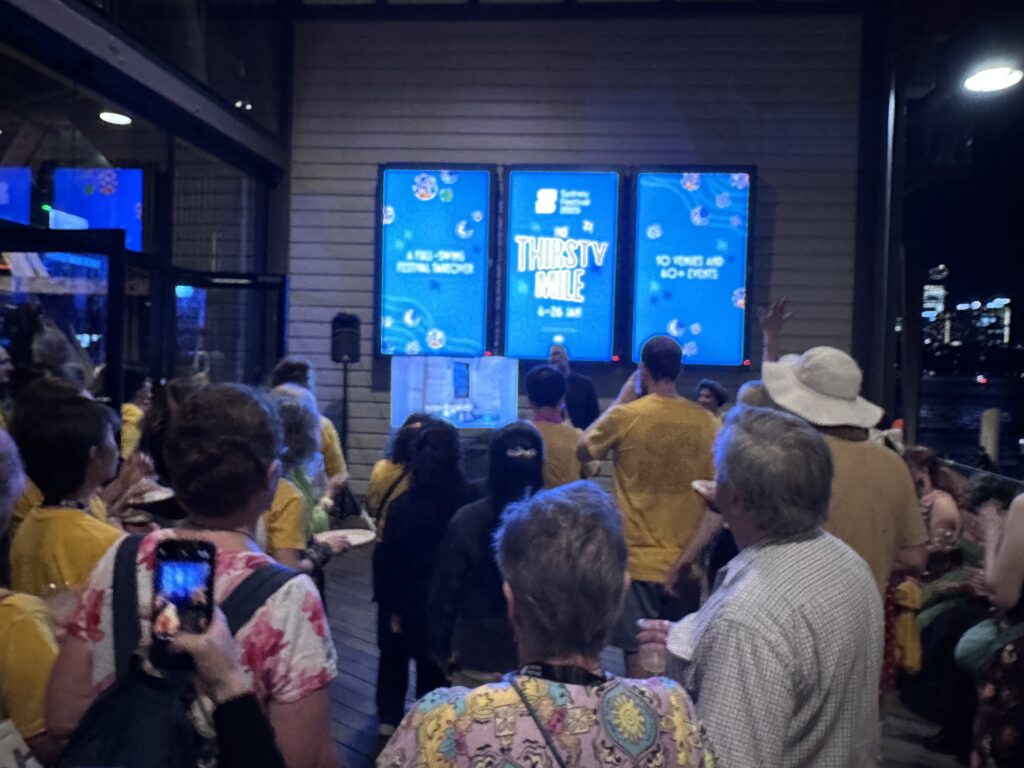 A crowd listening to the Sydney Festival CEO speak