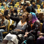 LOL - I'm watching an internal sneak preview of the #awscommunityday recap video, and the camera caught the moment @minxdragon and I took our selfie! 💜 (Full video will be published soon, I'm told.) https://t.co/hiie4bYJHl