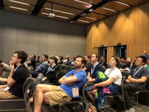 Loving @KenScambler's energy as he walks a large crowd through @REA_Group's FP journey. (Bonus points for the tiny @yow_conf t-shirt on the dev stick figure!) 👏💯 #Yow17 https://t.co/m7BX3QMpYv