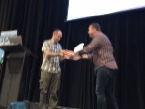 I'm not sure what just happened, but @delitescere just gave @jimwebber a baguette while introducing his talk on @neo4j. 😂 #yow17 https://t.co/Na6cThfOzU