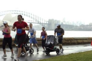 Me blowing past a couple guys with strollers in the Mother's Day Classic 8K.