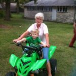 Grandma and Isaiah pretend to ride the 4-wheeler.