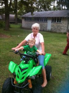 Grandma and Isaiah pretend to ride the 4-wheeler.