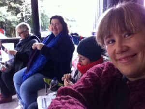 The power is out at knitting camp so we're all out on the porch to catch the light.