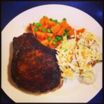 Massive pork chop (courtesy of Meat Emporium), coleslaw, and veg. #paleo #yum