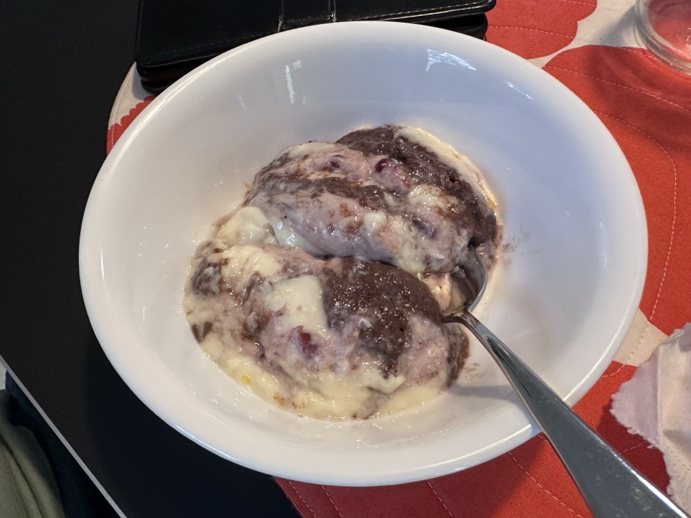 A bowl of chocolate, berry, and orange pudding